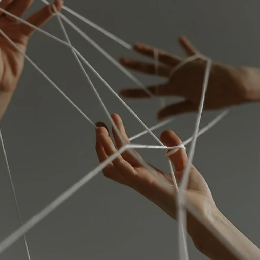 Hands and threads, representing the knot